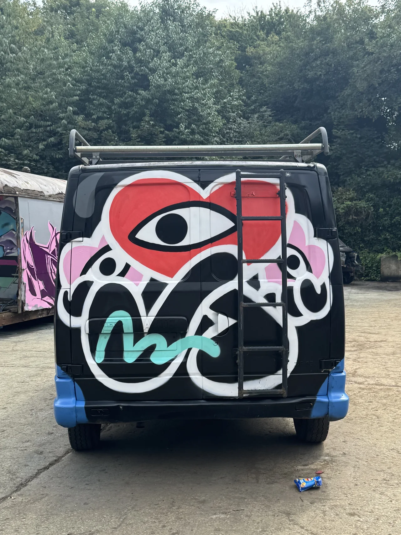A painted cartoon character on the rear of a dark van.