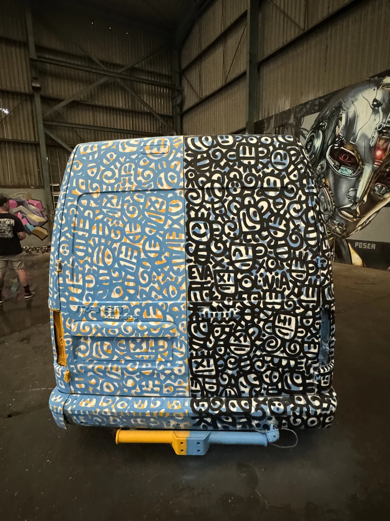 The back of a vehicle covered with a densely patterned black and white design.