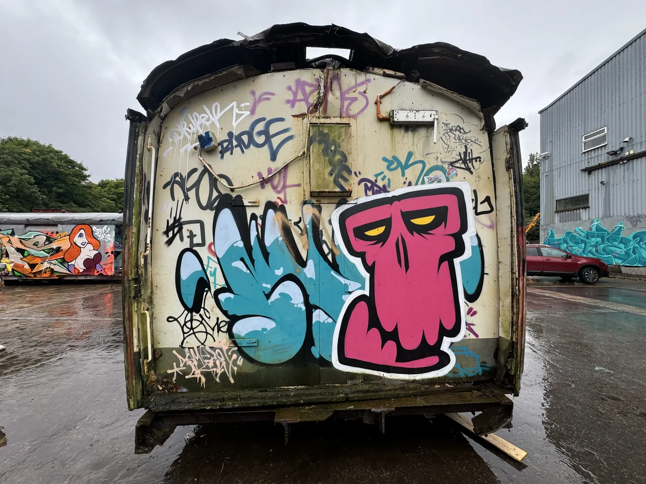 Blue and pink cartoon characters painted across the back of a trailer.