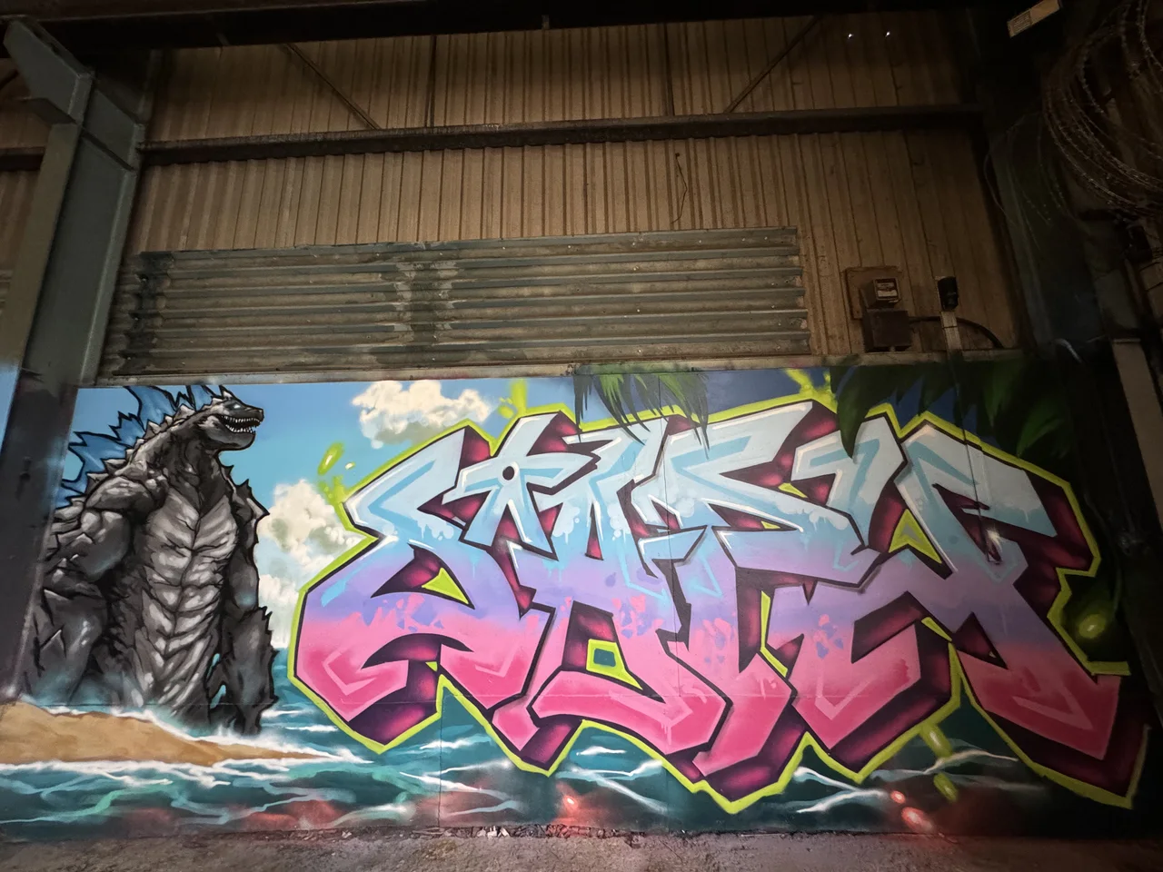 A workshop panel filled with angular pink and blue graffiti lettering.